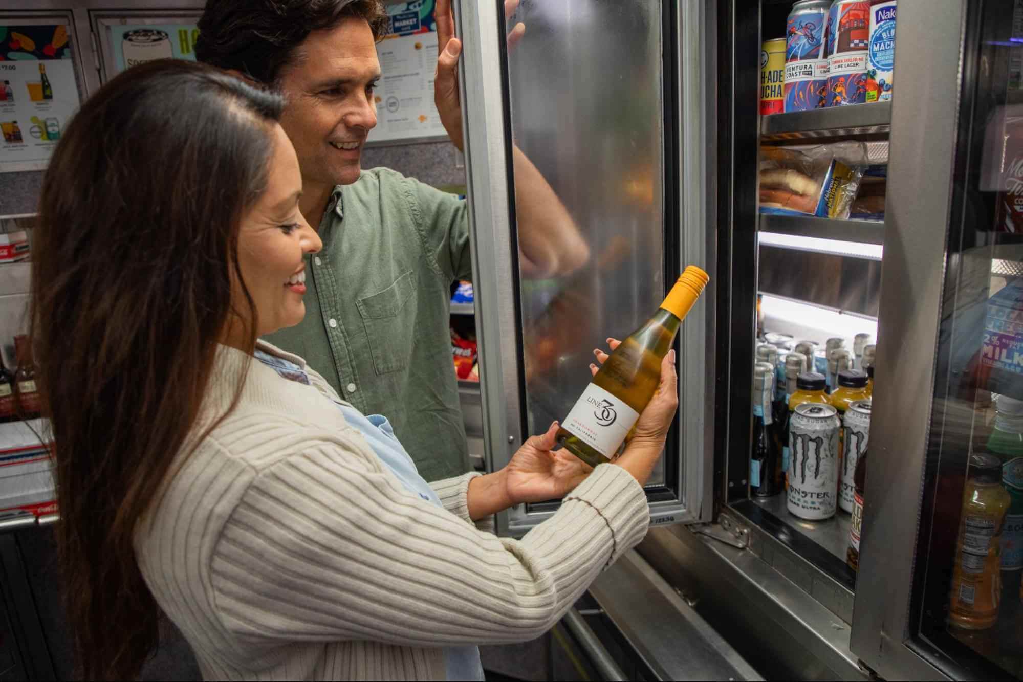 Passengers choosing a bottle of California wine from the Pacific Surfliner onboard Market Café car.