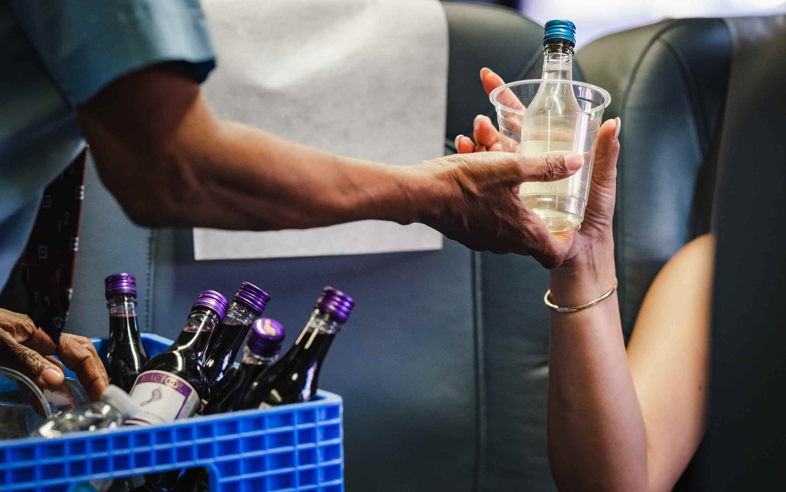 Passenger enjoying onboard California wine service aboard the Pacific Surfliner on the way to coastal wine country.