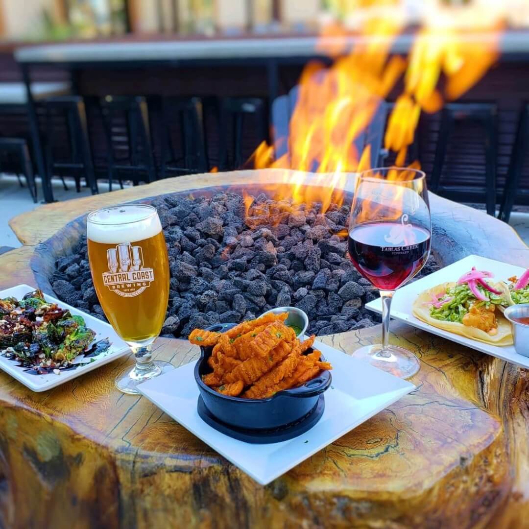 Craft beer and food by the fire pit at Central Coast Brewing in San Luis Obispo, California.