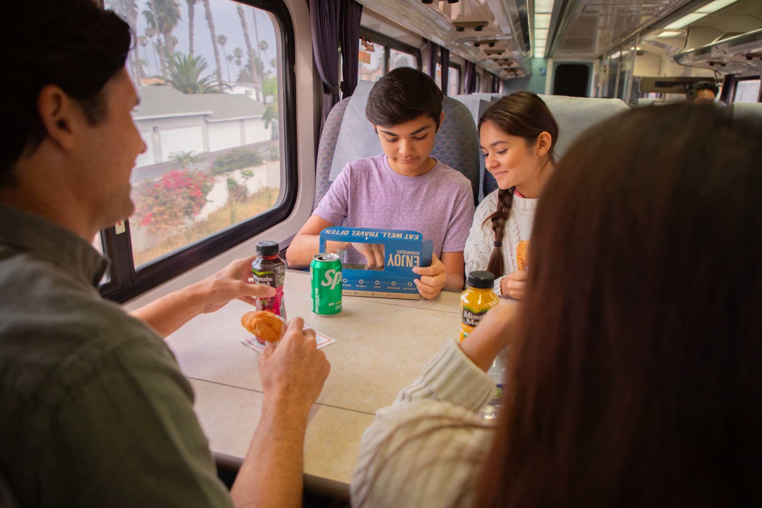 Family are eating in a train