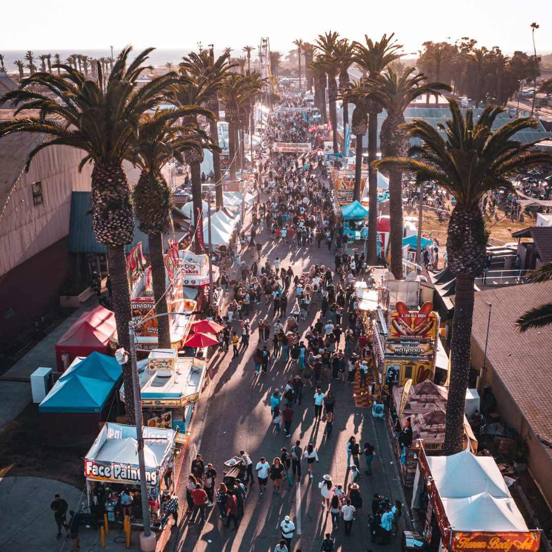 Ventura County Fair overhead view with palm trees, food vendors, and large crowds.