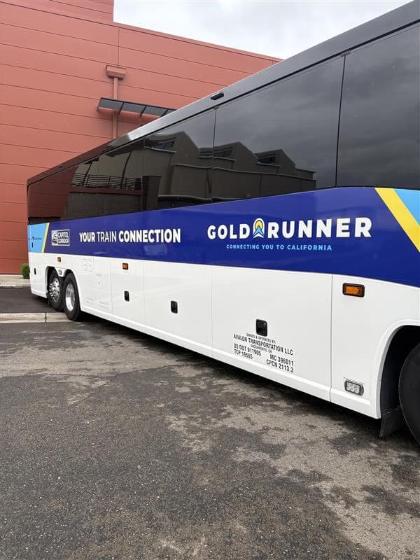 Bus with the inscription “Gold Runner” in the parking lot 