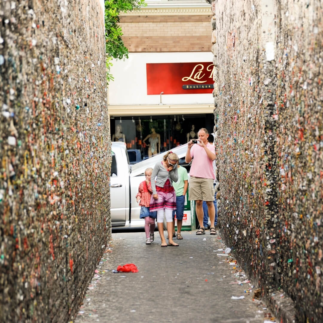 A family snaps a photo in downtown San Luis Obispo’s Bubblegum Alley.