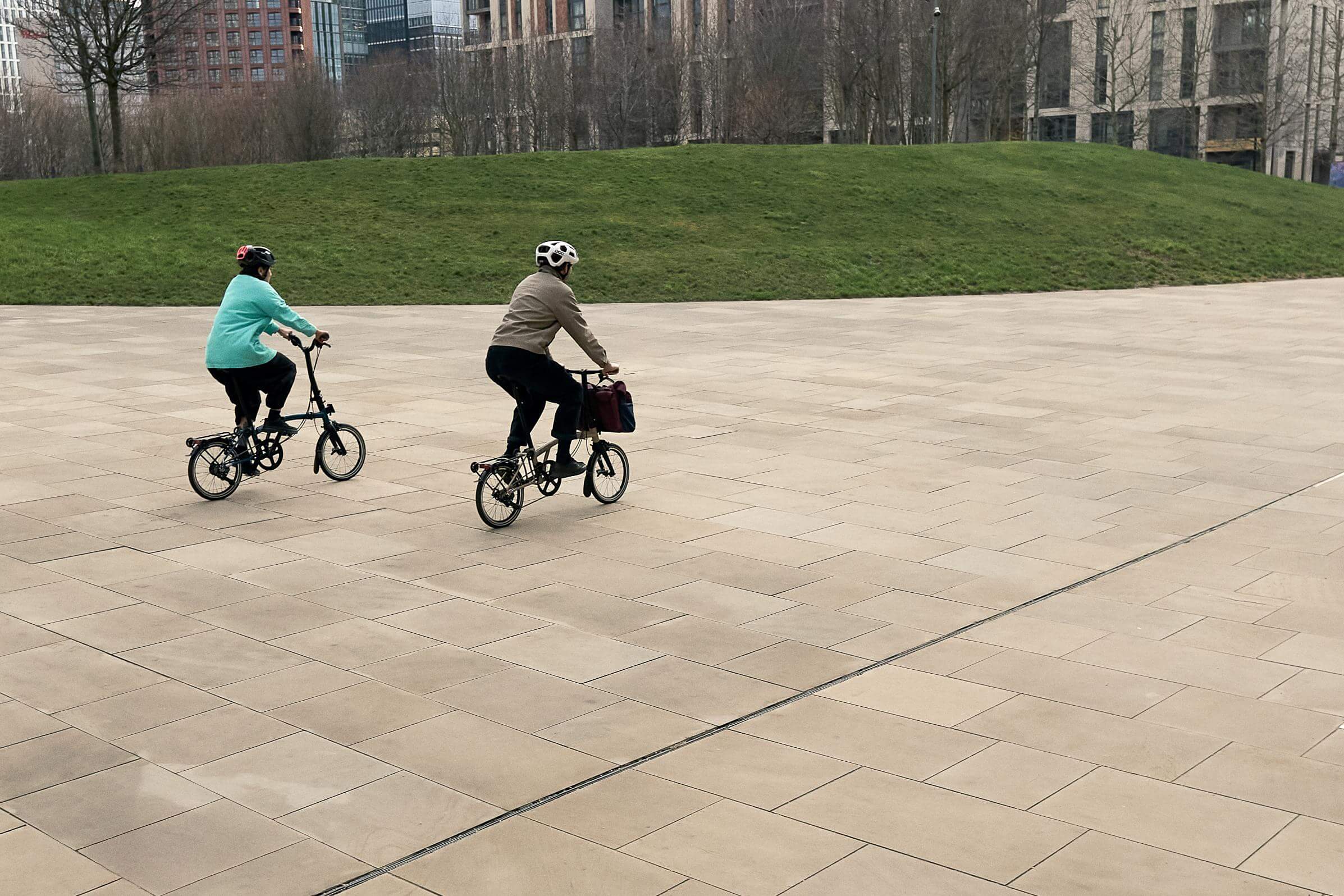 Two people riding foldable bikes