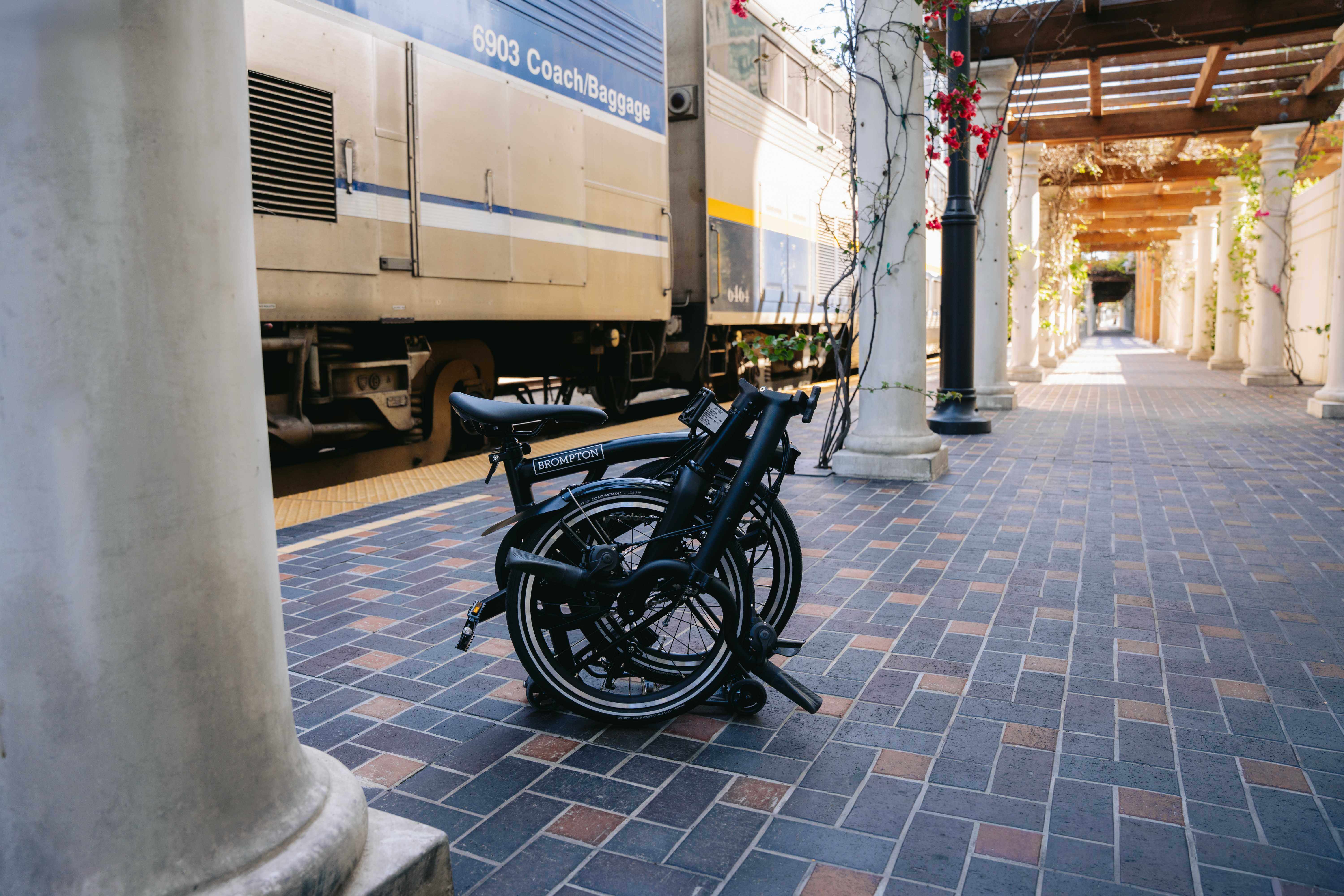 brompton folded bike with train in background
