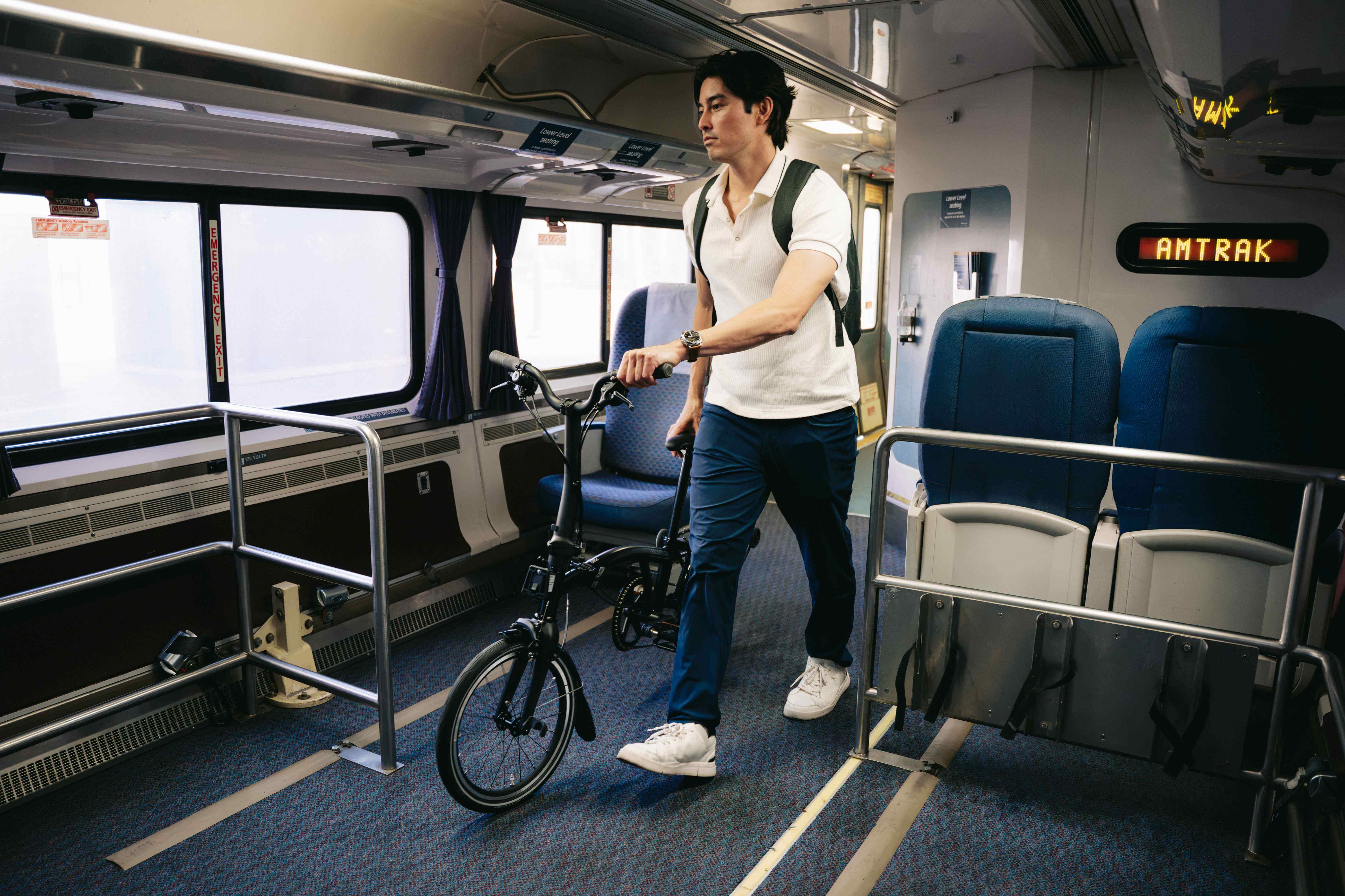 man walking bike on train